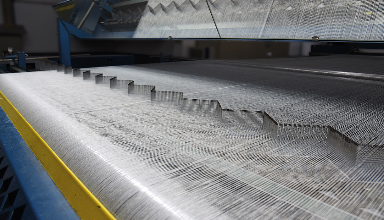 When the warp beam is placed, and the warp threads are correctly threaded the weaving can begin.